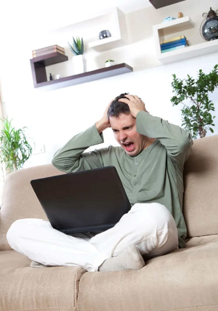 man yelling at a laptop screen